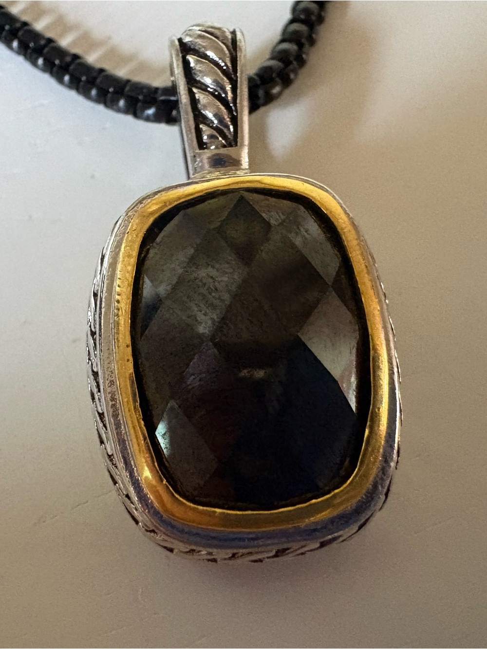 Silver and Gold Pendant with Faceted Dark Stone and Gold Accent and Black Neckla